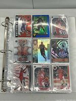 Photo showing binder page with 9 basketball cards featuring Toronto Raptors players Vince Carter and Pascal Siakam in plastic sleeves.