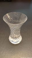 Front view of clear rippled crystal vase showing flared top and rippling on surface