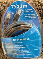 Clear packaging showing coiled gray network cable with RJ45 male connectors, length 7ft/2.1m, 24K gold plated, snagless design, DYNEX branding.