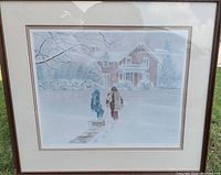 Framed art print showing full artwork and frame with two children walking in snow towards a house