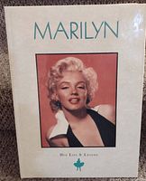 Front cover of the book titled 'Marilyn Her Life & Legend' featuring a color portrait of Marilyn Monroe.