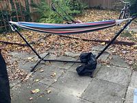 Full view of the assembled hammock with metal frame and multicolor cotton fabric