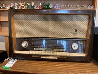 Front view of vintage Grundig 5088 radio showing control panel, missing tuner knob, speaker grille, and function buttons.