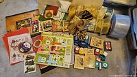 Overview of Christmas scrapbooking materials including papers, stamps, punches, and ribbons spread on floor
