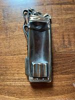 Top view of golf bag shaped metal ashtray showing detailed clubs and golf bag design.