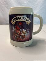Front view of Hobgoblin beer stein mug showing the hobgoblin character in Christmas theme with 'Ho, Ho, Ho' text