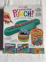 Front of sealed box showing Fashion Punch loom and example bracelets.