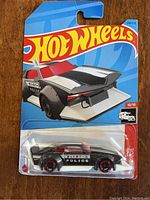 Front view of factory sealed Hot Wheels Mad Manga Police Car in original packaging, showing car design and packaging details
