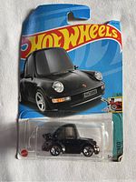 Front view of factory sealed Hot Wheels CarTooned Porsche 911 Turbo 3.6 (964) die-cast car in blister packaging with visible car and branding.