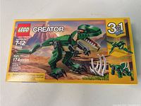Front of the box showing the main dinosaur model and the 3-in-1 label with alternate build images.