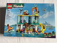 Front view of factory sealed Lego Friends Sea Rescue Center box showing model 41736 with 376 pcs, recommended age 7+. Box artwork shows the assembled rescue center with characters and water background.