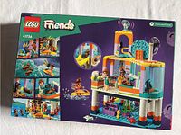 Front of the box showing the Lego Friends Sea Rescue Center set number 41736 with colorful images of the assembled rescue center and characters.