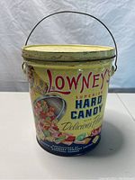 Front view of the vintage Lowney's Superior Hard Candy tin showing colorful candy illustrations and brand logo.