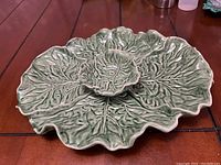 Overhead view of the ceramic platter showing leaf texture and central dip bowl.