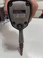 Bottom side view showing Campbell-Hausfeld label with model TL1052, 1/2 inch drive size, made in Taiwan.