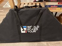 Black carrying case for poker table top with World Poker Tour logo