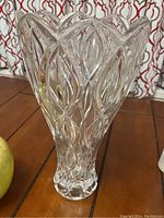 Front view of tall crystal vase showing detailed cut crystal pattern and weighted base.