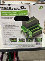 Photo of the original product box showing the TrekTerra branding, product name, and key features such as weight capacity, drawer with caddy, smooth ball bearing drawer, steel frame, and adjustable seat height.