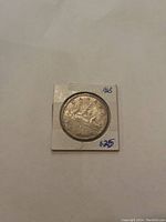 Reverse side of 1963 Canadian silver dollar featuring a canoe with two paddlers, the year '1963', and denomination 'DOLLAR'.