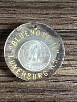 Front top view of the silver coin inside its plastic protective capsule showing the 'Bluenose II Lunenburg N.S.' text and the ship design on the coin