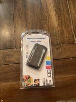 Front view of new USB step counter pedometer in sealed package with graphics and device visible.