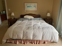 Queen bed setup with arched headboard and two matching nightstands