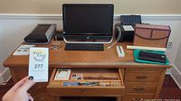 Desk setup with HP monitor, keyboard, mouse, printer, office supplies, and catalog card folder.
