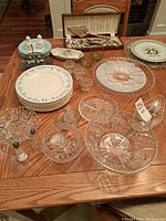 Full table display of the china sets, crystal dishes, and utensils showing quantity and layout