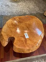 Circular top slab showing spruce burl grain and natural edge