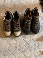 Two pairs of shoes side by side showing both colors and condition, brown and black Finn Comfort men's shoes.