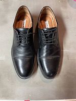 Top-down view of the pair of black leather Steve Madden dress shoes showing full shoe front and lace detail.