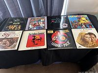 Eight soundtrack LP records arranged on a table with different covers visible including The Phantom of the Opera, Funatics, Leader of the Pack, The Endless Summer, Season of Desire, Sunflower.