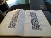 Open yearbook showing black and white portrait photos with handwritten signatures.