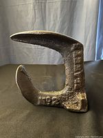 Front side view of cast iron cobbler anvil showing curved horn and solid base.