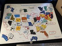 Full view of the magnetic collector's board showing most states in place with some states missing magnet pieces.