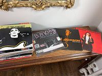 Stack of vinyl albums with visible titles including Lou Reed Transformer, B.B. King Midnight Believer, Meco Jackson Body and Soul, Melissa Etheridge red cover.