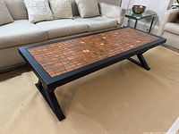 Front view of entire coffee table showing full tile mosaic top and frame