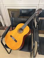 Guitar angled on chair showing full body, sides and top