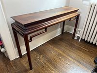 Side view of the wooden hallway table showing the rectangular top and leg details.