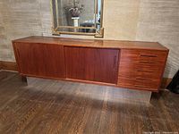 Front view showing entire credenza with four drawers on right and sliding doors on left