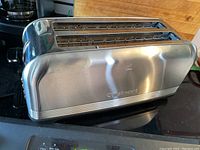 Another side angle showing toaster exterior and partial countertop setting.