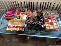 Full view of the ornaments sorted by color and type and the four large sugar pine cones in the middle