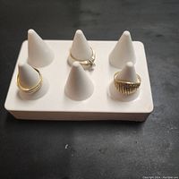 Front angle showing white rings holder with rings on some of the cone pegs.