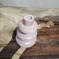 Handmade pink jesmonite vase with three stacked rounded layers shown from a slightly top angle.