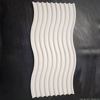 Top view showing smooth white wave design, ridges evenly spaced and flowing.