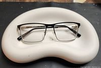 Top view of tray holding eyeglasses to show scale and use.