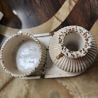 Top-down photo showing the vase and box placed on the tray, highlighting texture and gold leaf accents.