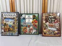 Three Graeme Base animal-related picture hardback books displayed side by side on a white surface.