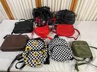All purses and backpacks displayed on a surface showing size, style and overall condition