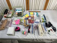 Full table view showing various crafting tools including scissors, tape, glue, and index cards